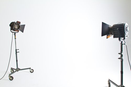 Video light fixtures on stands spaced out in flat white video studio